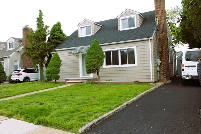 1535 Mattison St, Baldwin, NY 11510 - cape cod-style house with a chimney, a front yard, and roof with shingles