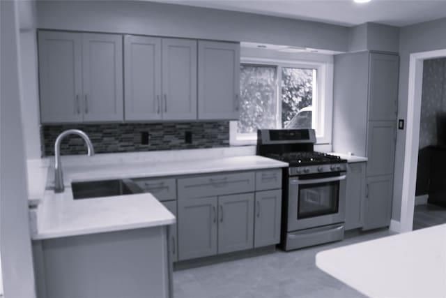 1535 Mattison St, Baldwin, NY 11510 - kitchen featuring gas stove, gray cabinetry, light countertops, and a sink