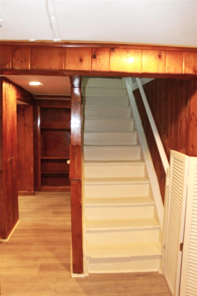 1535 Mattison St, Baldwin, NY 11510 - staircase featuring wood finished floors and wooden walls