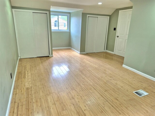 1535 Mattison St, Baldwin, NY 11510 - unfurnished bedroom featuring multiple closets, wood-type flooring, and baseboards