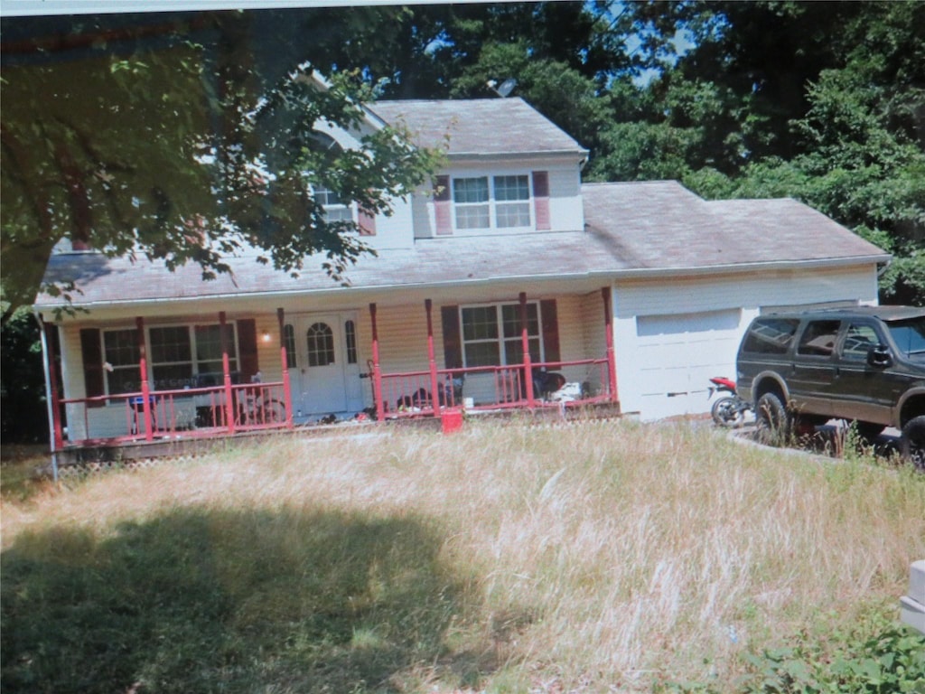 view of front of property featuring a porch and an attached garage