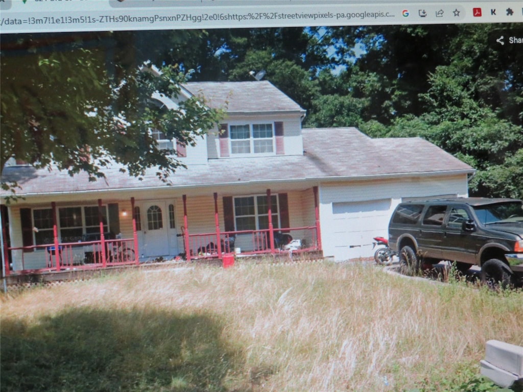 view of front facade featuring covered porch and a garage