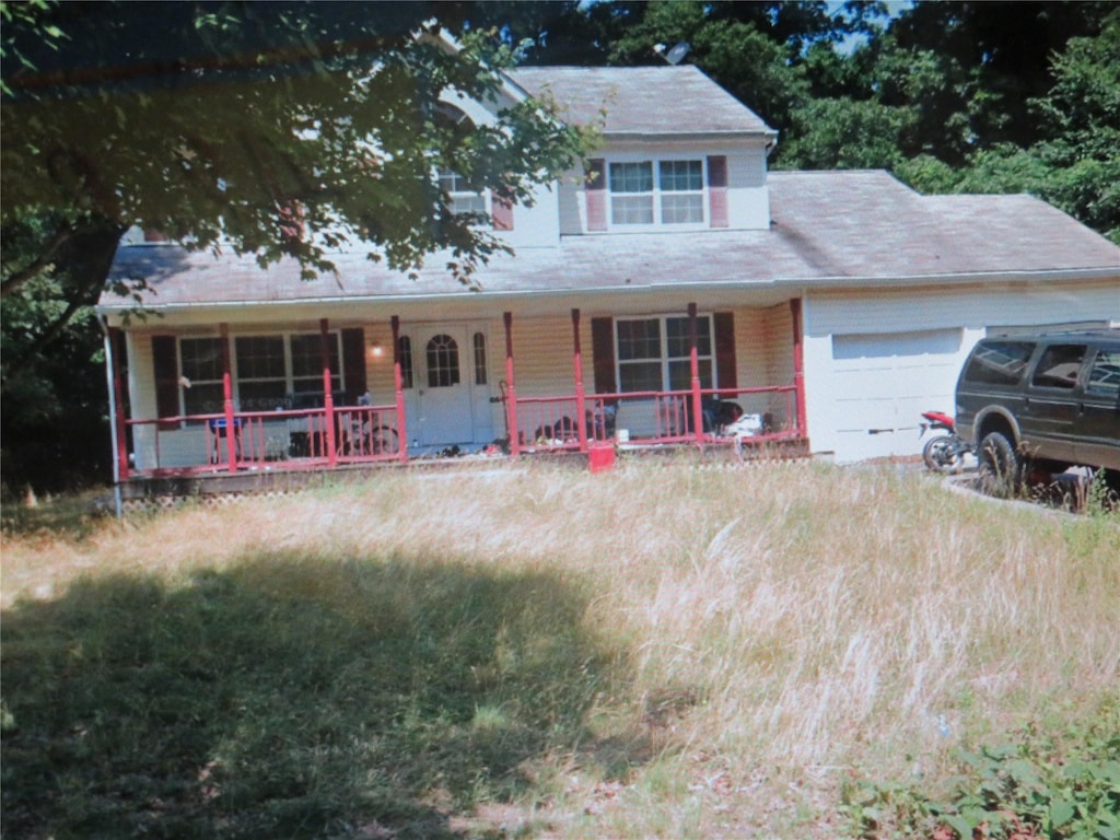 view of front facade with covered porch and an attached garage