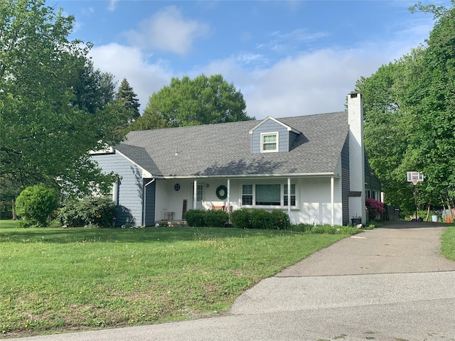20 Idlewild Park Dr, Cornwall On Hudson, NY 12520 - cape cod-style house featuring a chimney, a front yard, a shingled roof, and driveway