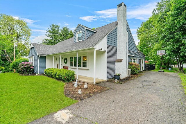 20 Idlewild Park Dr, Cornwall On Hudson, NY 12520 - view of front of home with a chimney, a front yard, driveway, and a shingled roof