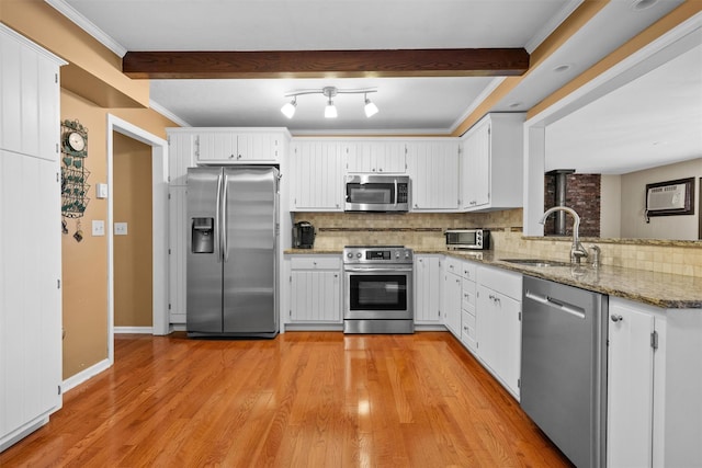 20 Idlewild Park Dr, Cornwall On Hudson, NY 12520 - kitchen with appliances with stainless steel finishes, a sink, tasteful backsplash, and light stone countertops
