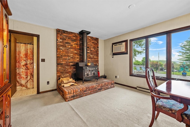 20 Idlewild Park Dr, Cornwall On Hudson, NY 12520 - carpeted home office with a wood stove, baseboard heating, and a wall mounted air conditioner