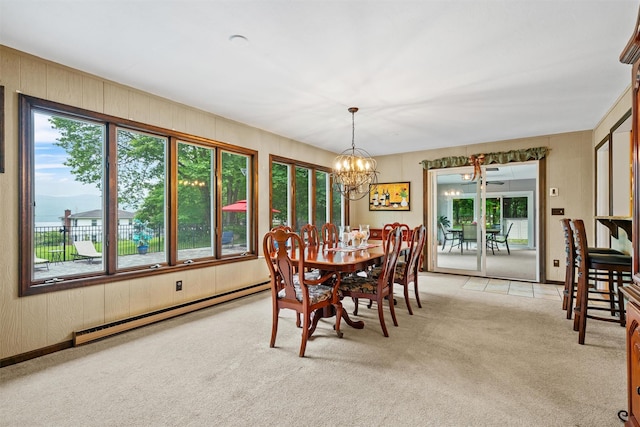 20 Idlewild Park Dr, Cornwall On Hudson, NY 12520 - dining room featuring a baseboard heating unit, light colored carpet, a chandelier, and wooden walls