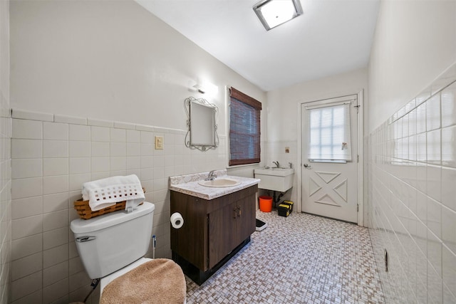 20 Idlewild Park Dr, Cornwall On Hudson, NY 12520 - bathroom with vanity, toilet, tile walls, and wainscoting