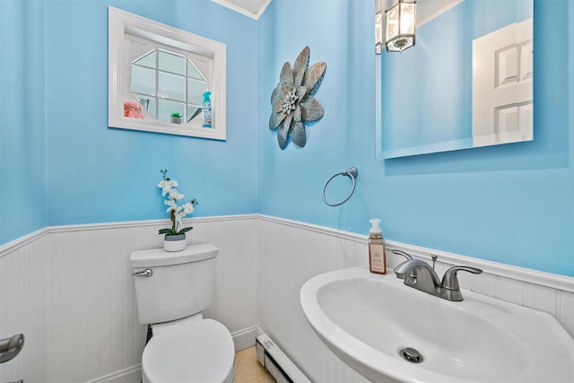 20 Idlewild Park Dr, Cornwall On Hudson, NY 12520 - bathroom with a sink, wainscoting, toilet, and baseboard heating