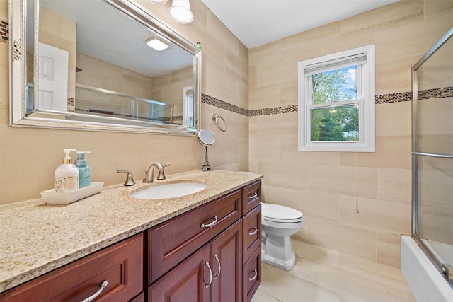 20 Idlewild Park Dr, Cornwall On Hudson, NY 12520 - full bathroom featuring tile walls, vanity, toilet, tile patterned flooring, and combined bath / shower with glass door