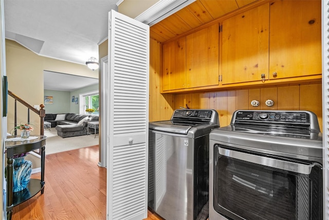 20 Idlewild Park Dr, Cornwall On Hudson, NY 12520 - laundry room with cabinet space, light wood-type flooring, and washer and clothes dryer