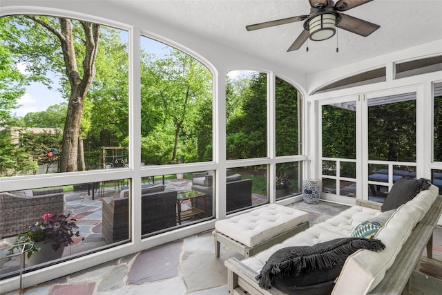 sunroom / solarium with outdoor lounge area, a ceiling fan, and healthy amount of natural light