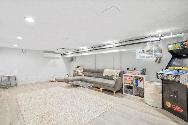 below grade area featuring wood finished floors, recessed lighting, and an AC wall unit