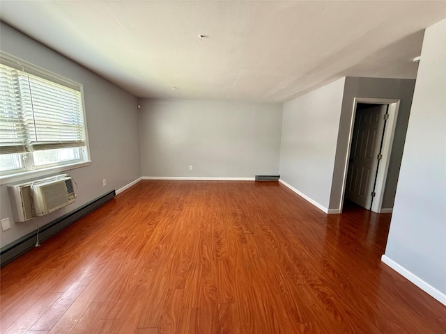 unfurnished room featuring wood finished floors and baseboards