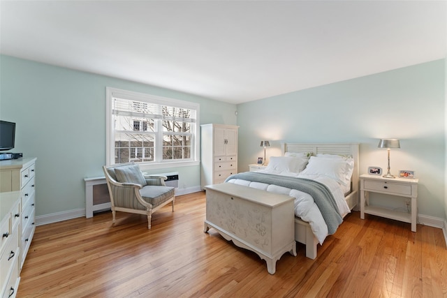 bedroom featuring light wood-style floors and baseboards