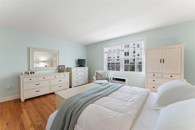 bedroom featuring light wood-style flooring and baseboards