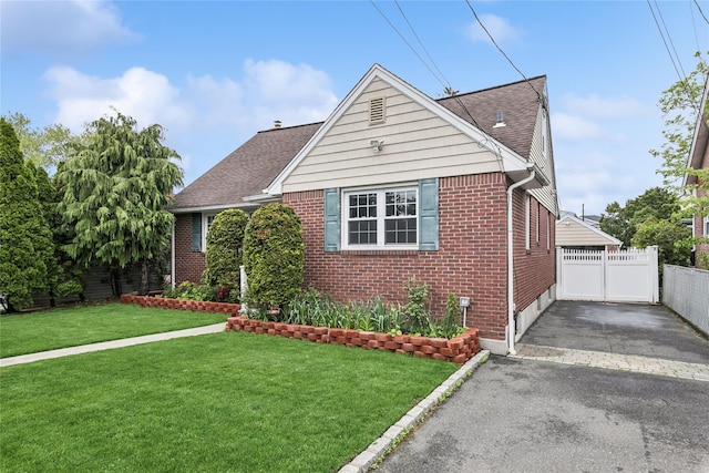 502S11th St., New Hyde Park, NY 11040 - view of front facade with brick siding, asphalt driveway, and roof with shingles