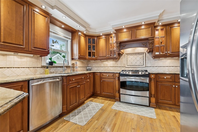 502S11th St., New Hyde Park, NY 11040 - kitchen with stainless steel appliances, a sink, brown cabinets, crown molding, and light stone countertops
