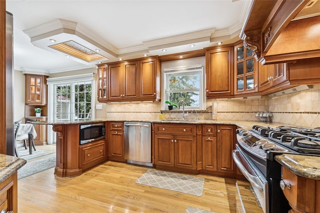 502S11th St., New Hyde Park, NY 11040 - kitchen featuring stainless steel appliances, a sink, brown cabinetry, ornamental molding, and a peninsula
