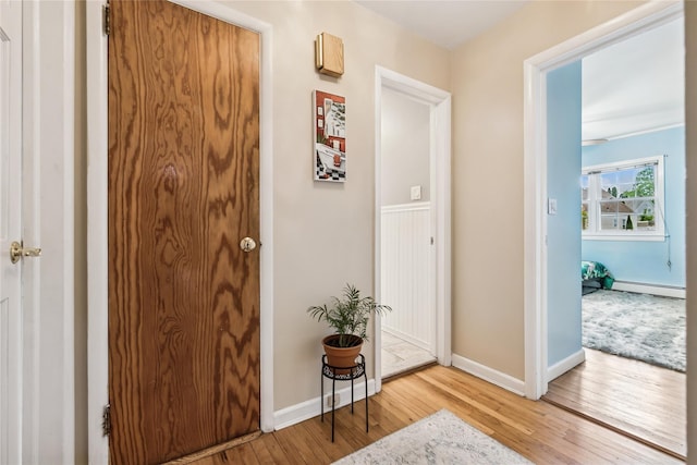 502S11th St., New Hyde Park, NY 11040 - entryway featuring light wood-style flooring, a baseboard radiator, and baseboards