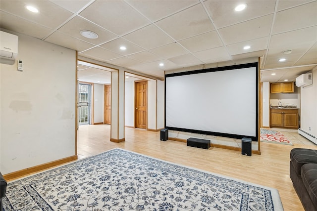 502S11th St., New Hyde Park, NY 11040 - home theater room with light wood-style floors, an AC wall unit, baseboards, recessed lighting, and a paneled ceiling