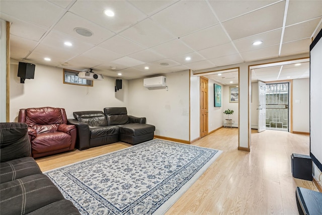502S11th St., New Hyde Park, NY 11040 - living area featuring a wall unit AC, light wood finished floors, baseboards, a drop ceiling, and recessed lighting