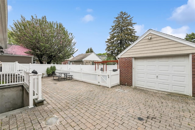 502S11th St., New Hyde Park, NY 11040 - view of patio featuring fence, a garage, and an outdoor structure