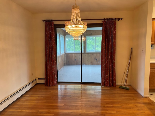 18 Prides Xing, Washingtonville, NY 10992 - unfurnished dining area featuring wood finished floors, baseboard heating, a chandelier, and baseboards