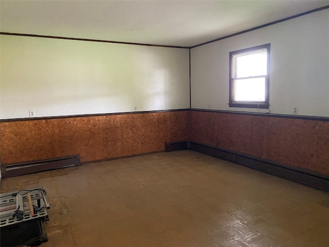 18 Prides Xing, Washingtonville, NY 10992 - empty room with a baseboard heating unit, a wainscoted wall, and tile patterned floors
