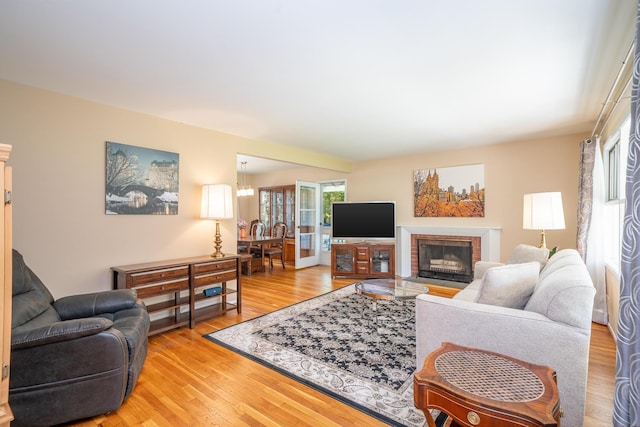 25 Ganung Dr, Ossining, NY 10562 - living room with light wood-style flooring and a brick fireplace