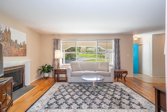 25 Ganung Dr, Ossining, NY 10562 - living area with a tiled fireplace, wood finished floors, and baseboards