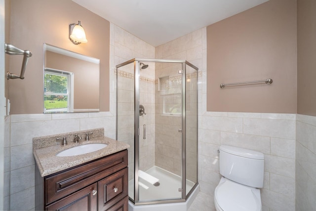 25 Ganung Dr, Ossining, NY 10562 - bathroom with tile walls, a stall shower, vanity, wainscoting, and toilet