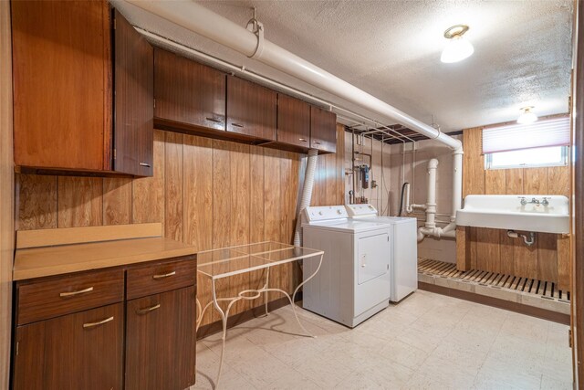 25 Ganung Dr, Ossining, NY 10562 - laundry room featuring independent washer and dryer, light flooring, cabinet space, and a textured ceiling
