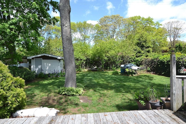 21 Northern Blvd, Shirley, NY 11967 - view of green lawn featuring a wooden deck, an outbuilding, and view of scattered trees