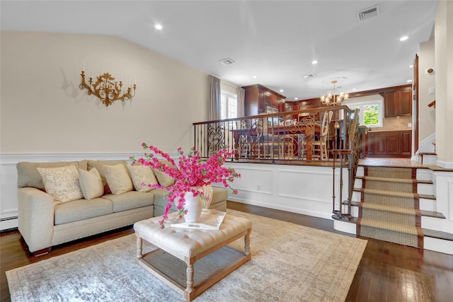 living room featuring stairs, a chandelier, wood finished floors, a decorative wall, and recessed lighting