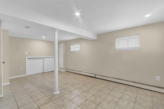 below grade area featuring baseboard heating, recessed lighting, light tile patterned floors, and baseboards