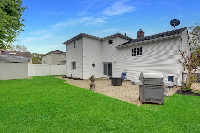 back of property featuring a patio and a chimney