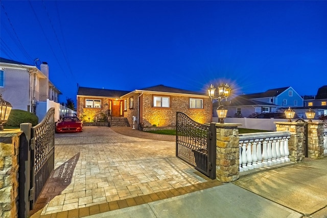 view of front of house featuring a gate and brick siding