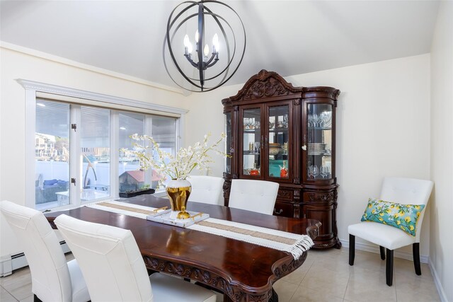 dining space with a chandelier, light tile patterned floors, and baseboards