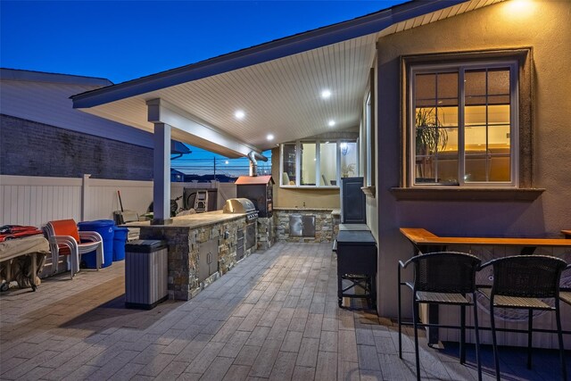 view of patio / terrace featuring exterior kitchen and fence