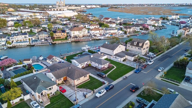 aerial perspective of suburban area with a nearby body of water