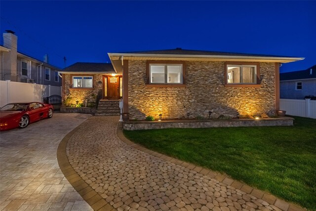 view of front facade with stone siding and decorative driveway