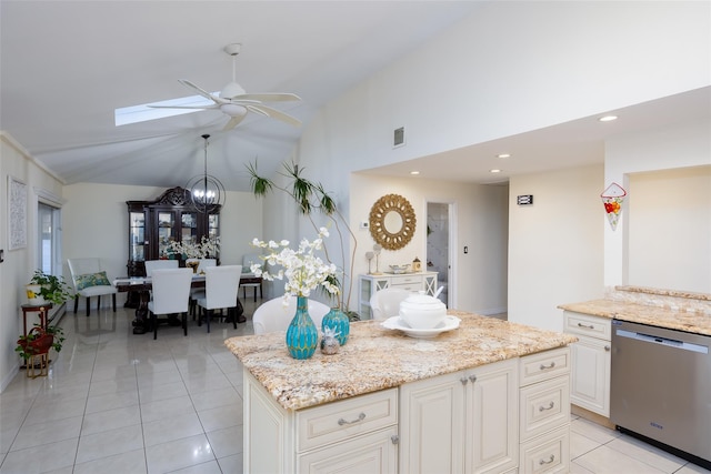 3449 Weidner Ave, Oceanside, NY 11572 - kitchen featuring stainless steel dishwasher, ceiling fan, a skylight, light tile patterned flooring, and light stone counters