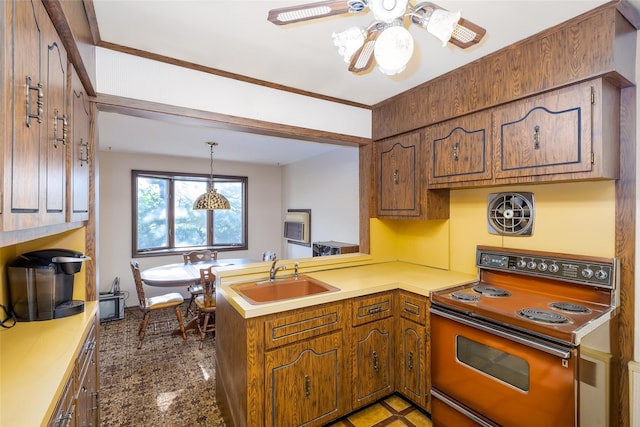 kitchen featuring electric range oven, a sink, a peninsula, a ceiling fan, and brown cabinetry