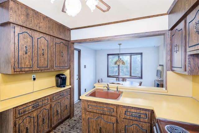 kitchen featuring a sink, light countertops, stainless steel microwave, electric range oven, and a peninsula