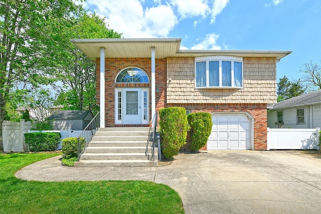 64 S Nassau St, Bethpage, NY 11714 - view of front of home with a garage, fence, driveway, and brick siding