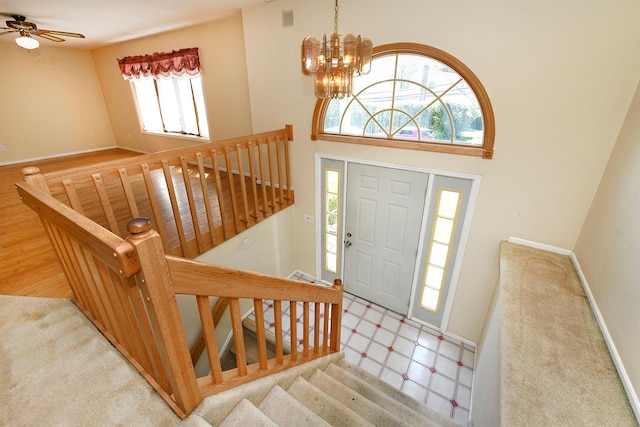 64 S Nassau St, Bethpage, NY 11714 - foyer entrance featuring baseboards, a chandelier, a ceiling fan, and a towering ceiling
