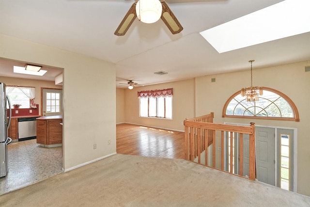 64 S Nassau St, Bethpage, NY 11714 - foyer with a skylight, a ceiling fan, a chandelier, baseboards, and light colored carpet