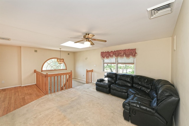 64 S Nassau St, Bethpage, NY 11714 - living room featuring ceiling fan, a skylight, wood finished floors, and baseboards